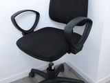 a black office chair that is sitting on the floor