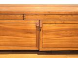 a wooden cabinet with two doors and a drawer on it