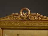 a gold frame with a picture of a bird and flowers on it