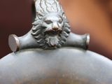 a statue of a man with a beard on top of a vase