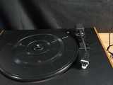 a record player sitting on top of a wooden table