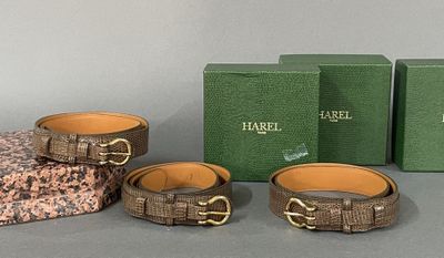 three pieces of leather bracelets and a green box on a table