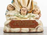 a figurine of a woman holding a baby