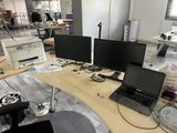 a desk with three monitors and a laptop on it