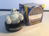 a toy car tire with a michel michel figurine on it