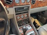 a dashboard of a car with a clock and a steering wheel