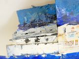 a close up of a piece of art with blue paint on it