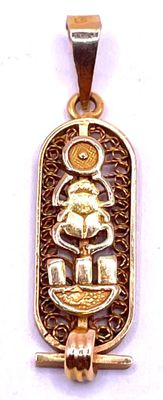 an image of a gold plated pendant with a picture of a boat on it