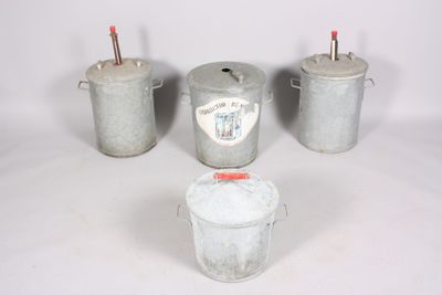 three buckets with lids and handles are sitting next to each other