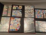 many different types of stamps on the pages of a binder