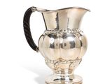 an image of a silver pitcher with a black handle on a white background