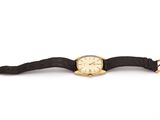 an image of a gold watch with a black strap