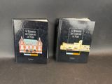 two books sitting on top of a table next to each other