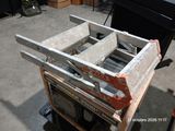 a stack of boxes sitting on top of a wooden cart