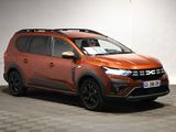 the orange car is parked in a garage with a checkered floor