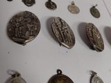 a lot of silver coins on a white surface