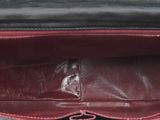 the inside of a black and red purse with a zipper open