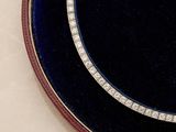 a black plate with a blue and white design on it