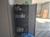 a metal cabinet with a door open in a room