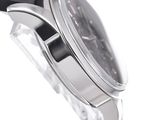 a close up of a watch on a white surface