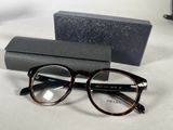 glasses and a case on a table with a pair of glasses on it