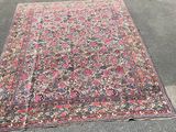 an old rug is laying on the ground in a parking lot