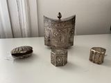 three silver objects sitting on a table next to each other