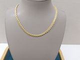 a close up of a mannequin with a gold chain on it