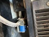 a close up of a car ' s air conditioner with a hose attached to it