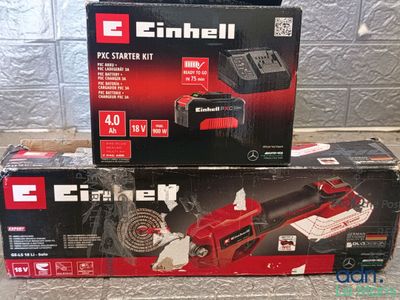 two boxes of electric tools sitting on top of a table