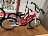two bikes that are sitting on a shelf in a room