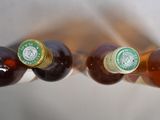 bottles of beer are lined up in a row on a table