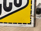 a close up of a yellow and black sign on a table