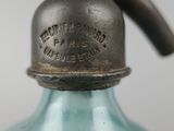 a blue glass bottle with a metal cap on it