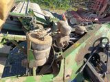 a tractor that is parked next to a pile of machinery