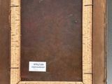 an old wooden picture frame with a label on the inside of it