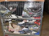 a metal cart with many items in it in a warehouse