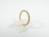 a close up of a yellow gold ring on a clear acrylic stand
