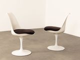 pair of tulip chairs by eero in white and black leather