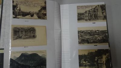 an open book with a bunch of old photos on it