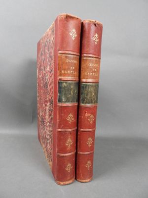 two red books sitting on top of each other on a gray surface