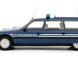 a blue police car that is parked on the side of the road