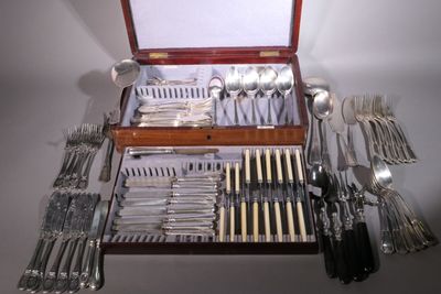 a wooden case with silverware in it on a table