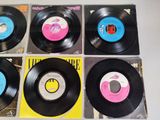 six vinyl records sitting on top of each other on a table