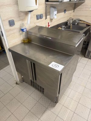 a stainless steel sink in a kitchen with a lot of counter space