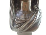 a bronze statue of a woman with a crown on her head