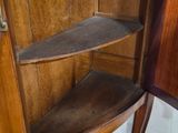 a corner cabinet with a marble top in a room