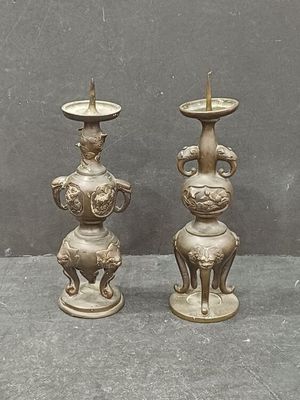 two candles that are sitting on a table