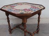 a small wooden table with a floral design on it