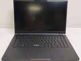 a laptop computer sitting on a table with a black keyboard